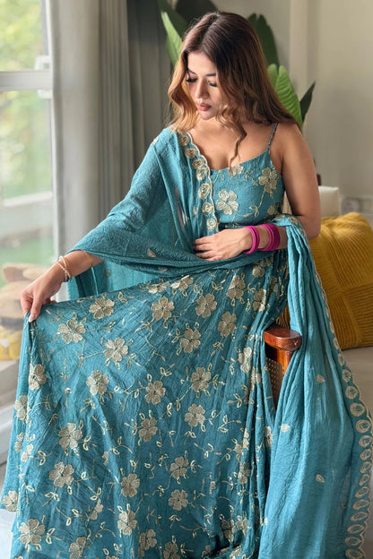 Teal embroidered fancy silk Anarkali suit.