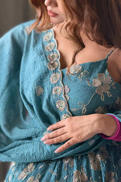 Teal embroidered fancy silk Anarkali suit.