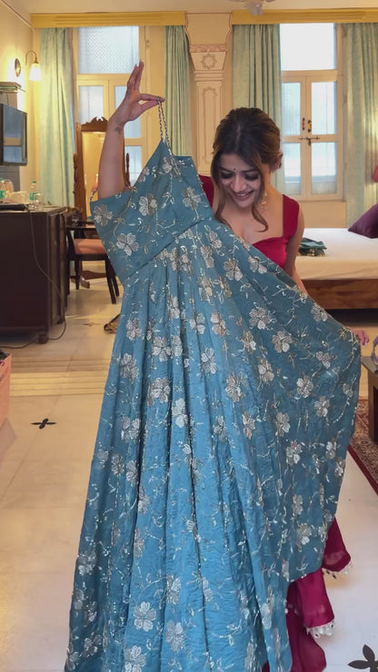 Teal embroidered fancy silk Anarkali suit.